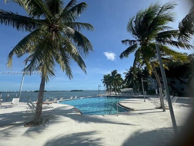 view of pool featuring a water view