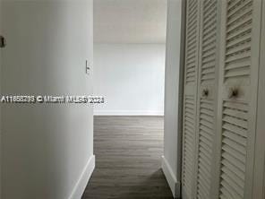 13499 Biscayne Blvd Unit 801, North Miami, FL 33181 - hallway featuring baseboards and dark wood-type flooring