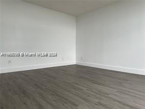 13499 Biscayne Blvd Unit 801, North Miami, FL 33181 - unfurnished room with baseboards and dark wood-style flooring
