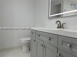 bathroom featuring vanity, toilet, and tile patterned floors