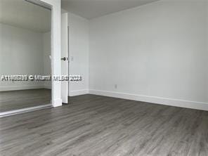 unfurnished room featuring dark hardwood / wood-style flooring