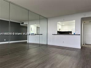 13499 Biscayne Blvd Unit 801, North Miami, FL 33181 - unfurnished living room featuring wood finished floors and baseboards