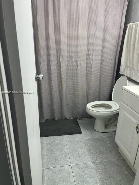 10411 SW 108th Ave Unit 153, Miami, FL 33176 - bathroom with tile patterned floors, toilet, and vanity