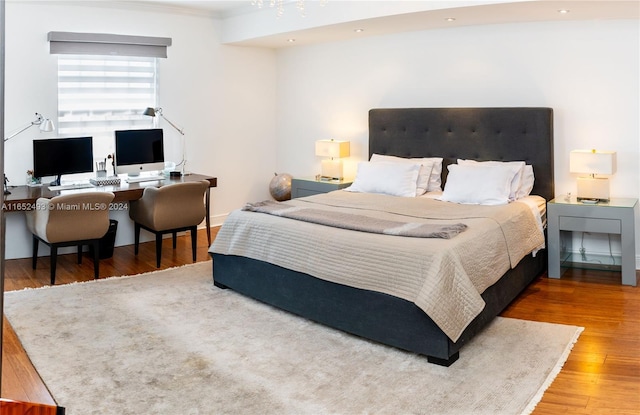 bedroom featuring ornamental molding and hardwood / wood-style floors