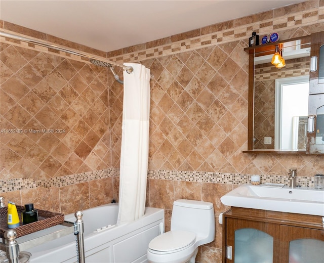 full bathroom with shower / bath combo with shower curtain, tile walls, toilet, and vanity