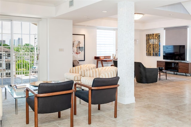 living room featuring a healthy amount of sunlight and ornamental molding