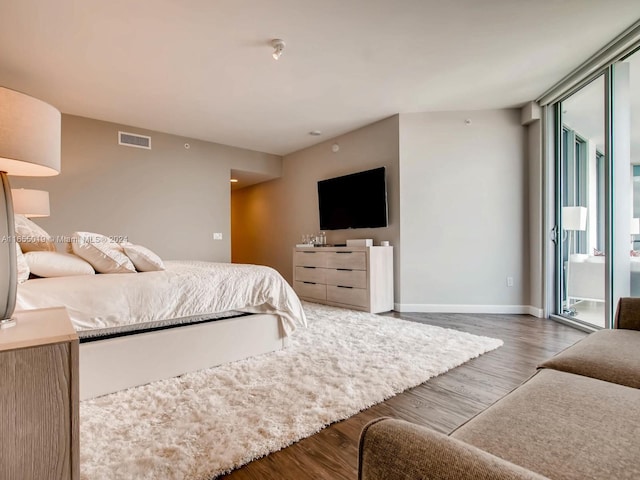 bedroom with dark hardwood / wood-style floors