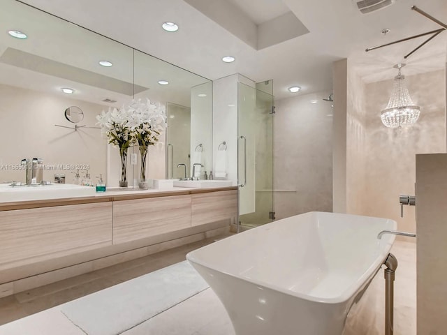 bathroom featuring vanity, plus walk in shower, a notable chandelier, and tile patterned floors