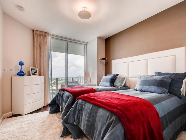 bedroom featuring access to exterior and wood-type flooring