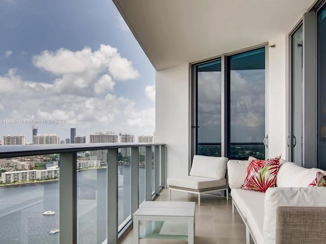 balcony with outdoor lounge area and a water view