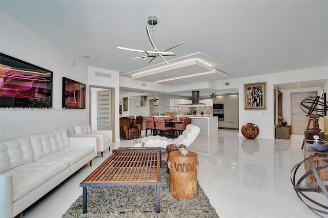 living room with light tile patterned flooring and an inviting chandelier