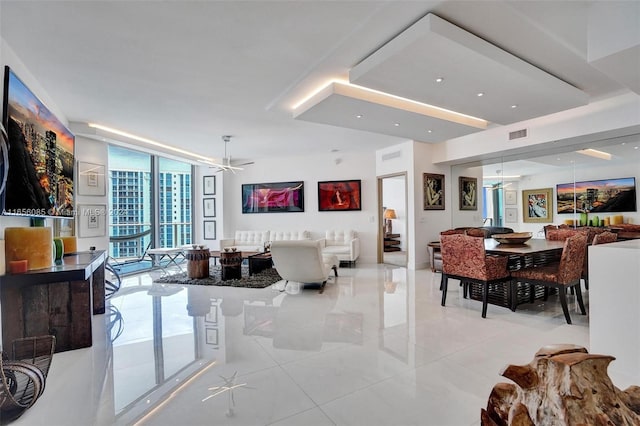 living room featuring floor to ceiling windows, light tile patterned floors, and ceiling fan