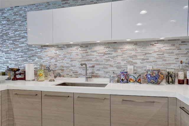 kitchen with backsplash, sink, and light brown cabinets