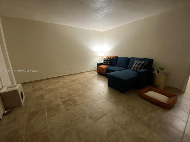 unfurnished room with a textured ceiling