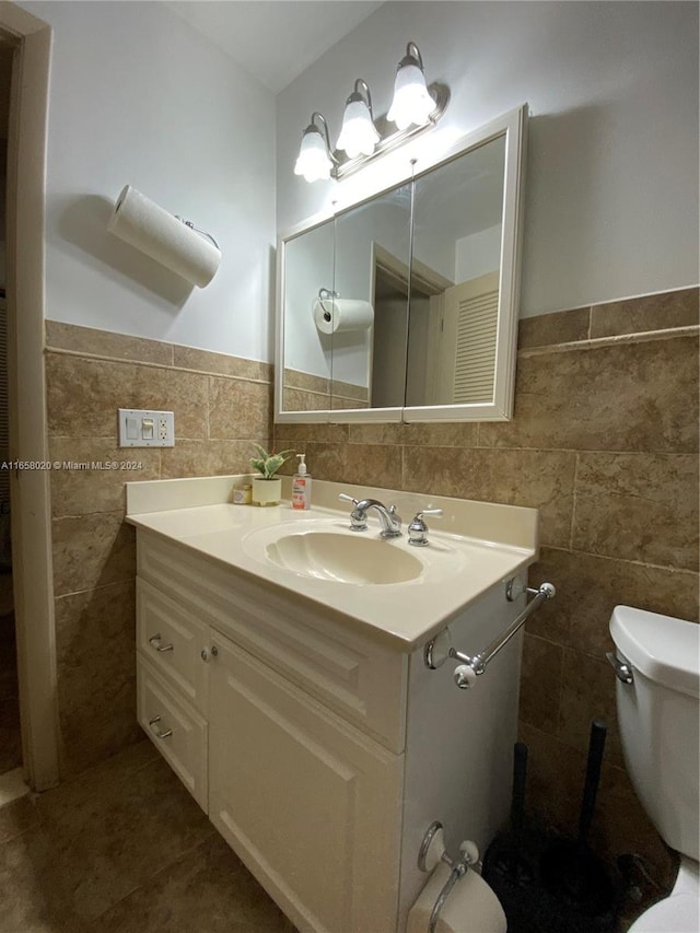 bathroom with tile walls, toilet, tasteful backsplash, and vanity