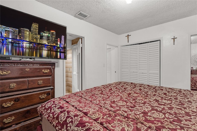 bedroom with carpet floors and a textured ceiling