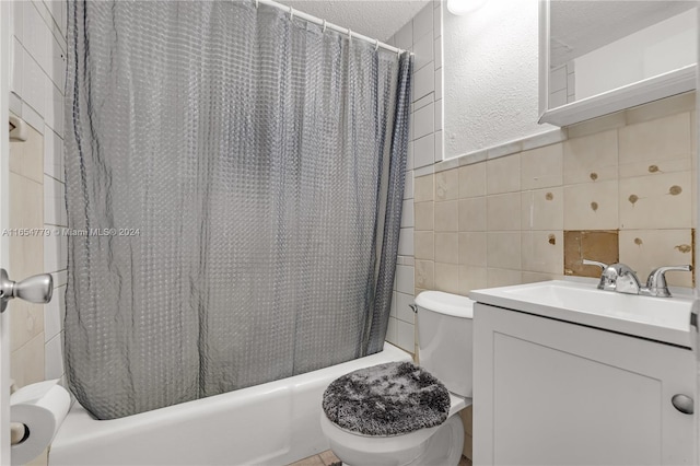 full bathroom with tile walls, toilet, shower / tub combo with curtain, and vanity