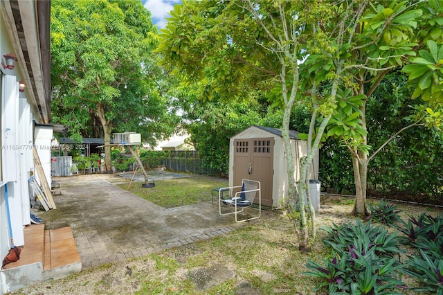 view of yard featuring a storage shed and a patio area