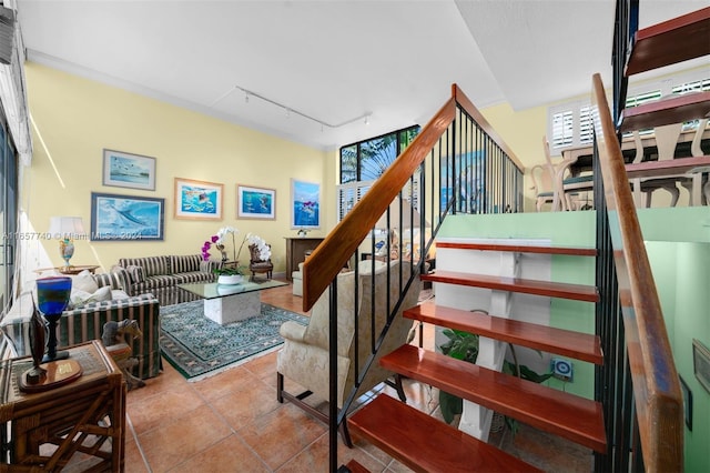 staircase with rail lighting and tile patterned floors