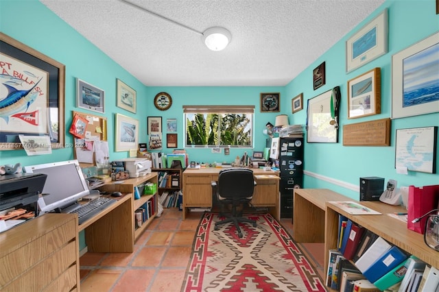 office area featuring a textured ceiling and light tile patterned flooring