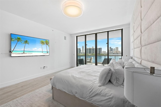 bedroom featuring light hardwood / wood-style floors and access to outside