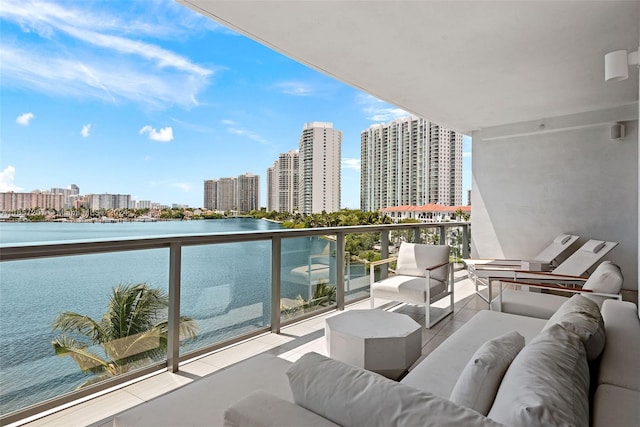 balcony featuring a water view and an outdoor hangout area