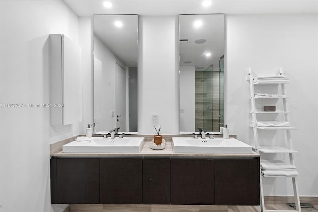 bathroom featuring vanity, hardwood / wood-style floors, and a shower with shower door