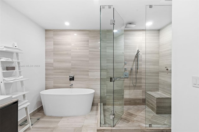 bathroom featuring separate shower and tub and vanity