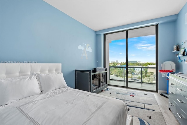 bedroom featuring access to exterior and floor to ceiling windows