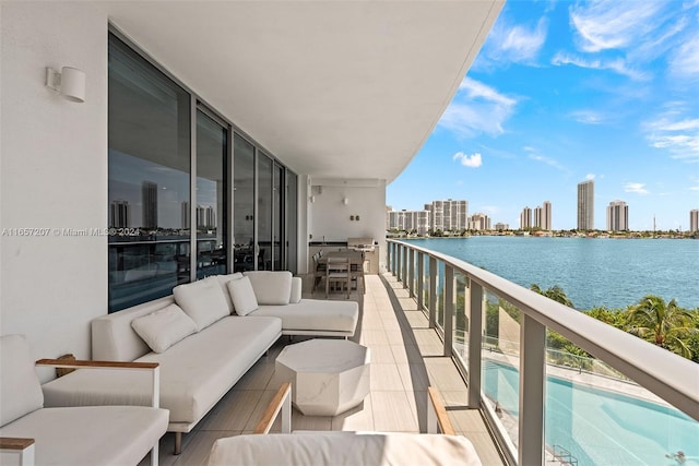 balcony featuring an outdoor hangout area and a water view