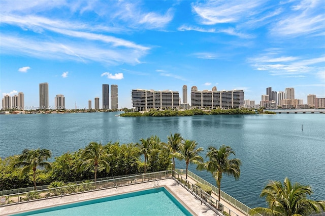 view of swimming pool with a water view