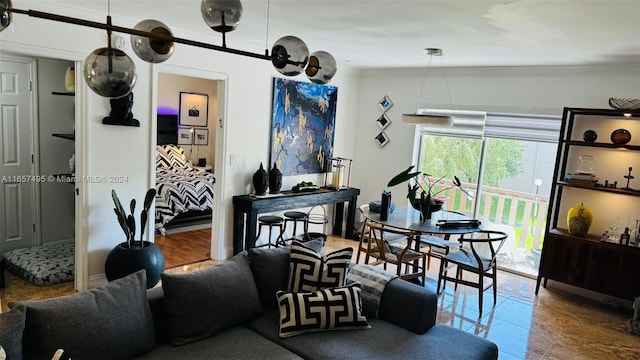 living room featuring a barn door and ornamental molding