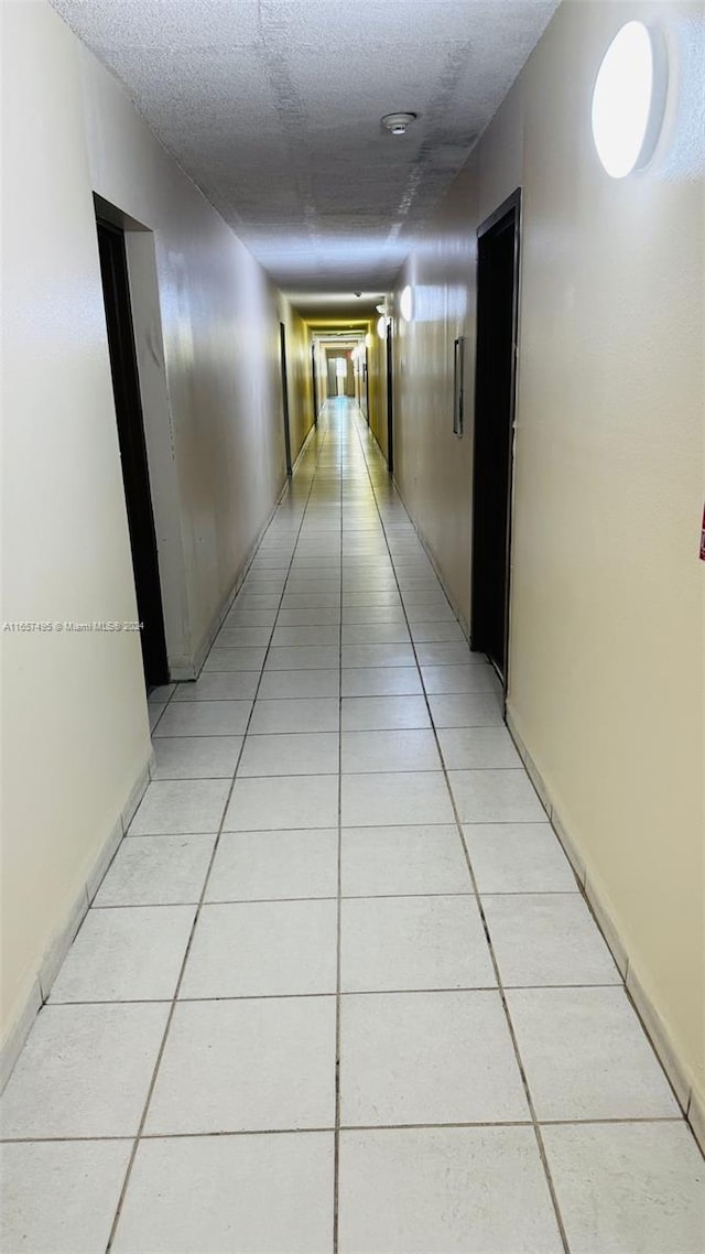 corridor with light tile patterned floors