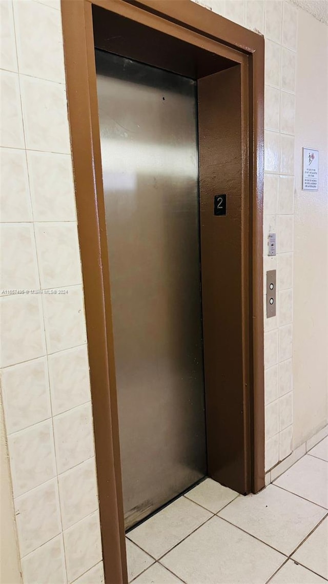 room details featuring elevator and tile patterned floors