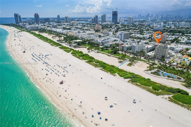 aerial view featuring a view of the beach and a water view