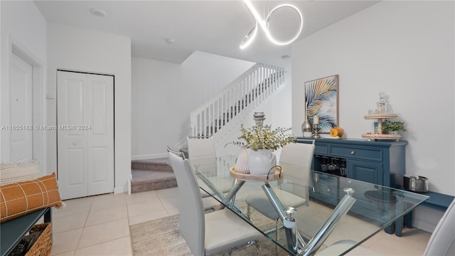 dining area with a chandelier and light tile patterned floors