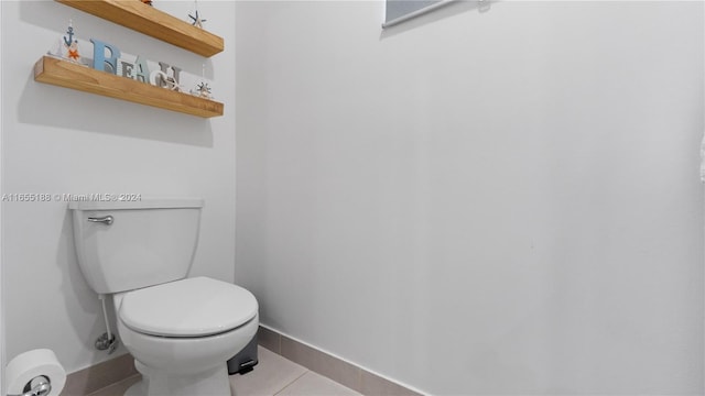 bathroom featuring tile patterned flooring and toilet