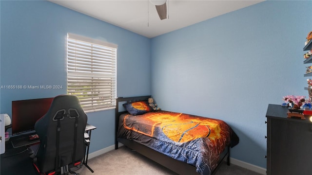 bedroom featuring ceiling fan and light carpet