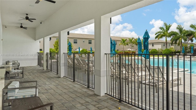 view of patio featuring ceiling fan and a community pool