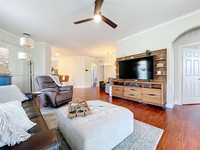 living room with crown molding, ceiling fan, and dark hardwood / wood-style floors