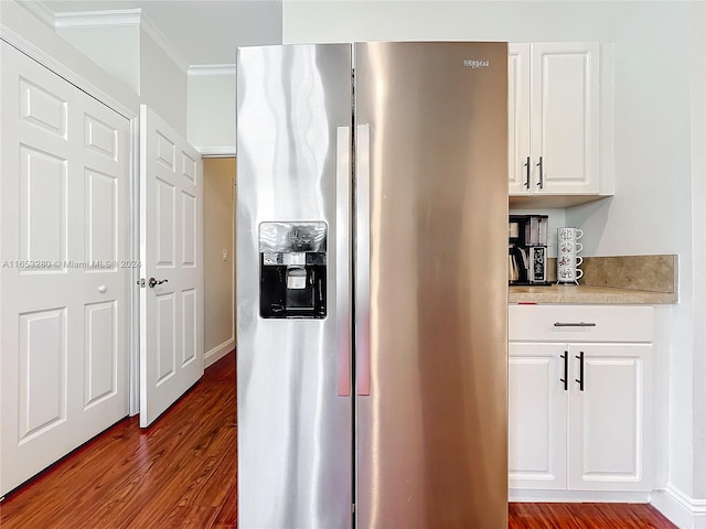 kitchen featuring ornamental molding, hardwood / wood-style floors, white cabinetry, and stainless steel refrigerator with ice dispenser