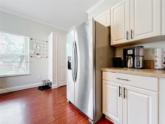 kitchen with stainless steel refrigerator with ice dispenser, dark wood-type flooring, crown molding, and white cabinetry