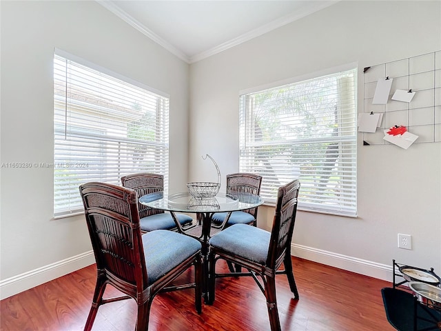 dining area featuring crown molding and hardwood / wood-style floors