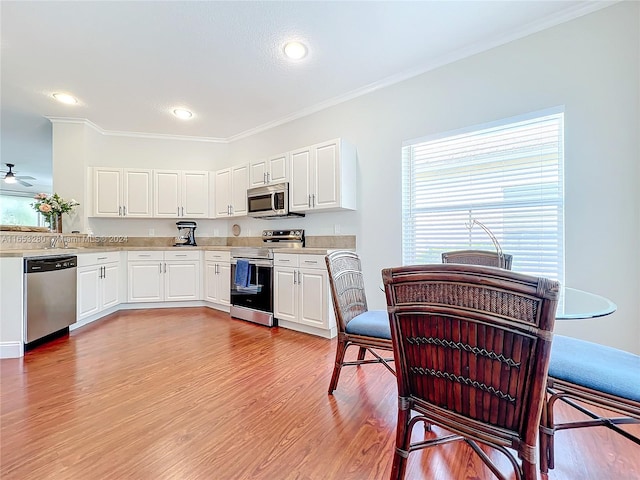 kitchen featuring white cabinetry, light hardwood / wood-style flooring, stainless steel appliances, and ceiling fan