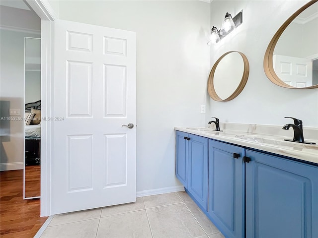 bathroom featuring hardwood / wood-style floors, crown molding, and vanity