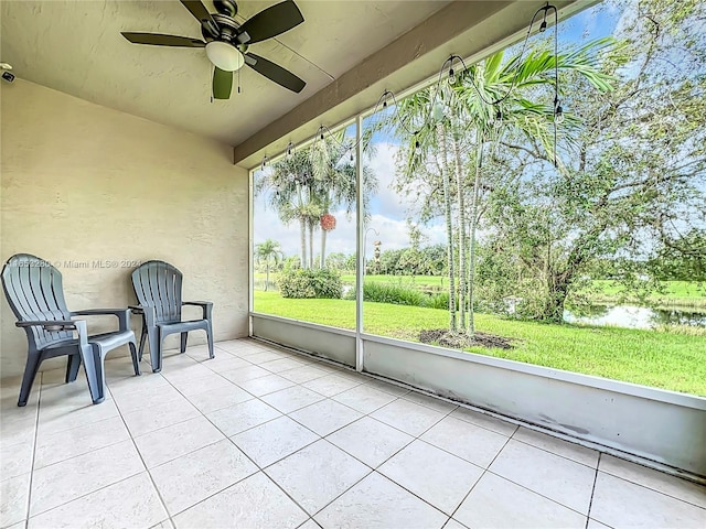 unfurnished sunroom with ceiling fan