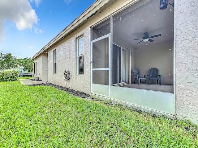 view of property exterior featuring ceiling fan and a yard