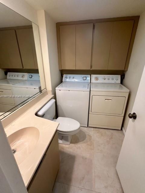 bathroom with tile patterned floors, vanity, separate washer and dryer, and toilet