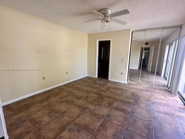 unfurnished room with a wealth of natural light, a textured ceiling, and ceiling fan