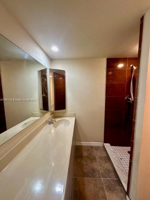 bathroom featuring tile patterned floors, vanity, and tiled shower